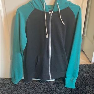 Grey jacket green sleeves and hood